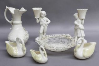 A Small Group of Belkeek China, comprising a ewer, a pair of figural candlesticks, a twin handled