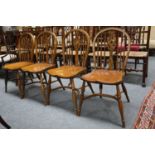 A Set of Four Oak Windsor Chairs, each with crinoline stretcher