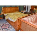 An Oak Sleigh Bed, 20th century, 196cm by 230cm by 112cm