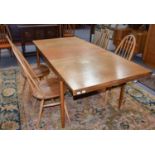 A Teak Extending Dining Table, mid 20th century, 191cm (open) by 89cm by 72cmA Similar Sideboard,