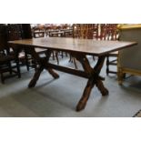 An Oak Refectory Table, the X-form supports joined by a stretcher, 183cm by 83cm by 76cm