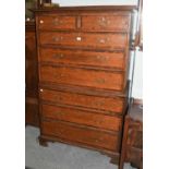 A George III Oak Chest on Chest, crossbanded in mahogany, with cock beading and raised on bracket