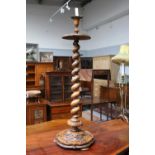 A Victorian Carved Walnut Candlestand, circa 1870, the moulded dished top above a spiral turned