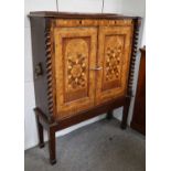 A Parquetry Inlaid Two Door Cabinet, 19th century, with boldly turned pilasters on square section