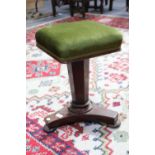 A Regency Mahogany Adjustable Piano Stool, with tapering faceted supports on a waisted tri-form base