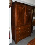 A George III Mahogany Press Cupboard, with dentil moulded frieze, banded in satinwood, raised on