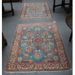 A Pair of Tabriz Rugs, each with aquamarine fields of large flower heads enclosed by ivory