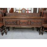 A Carved Oak Dresser Base, 19th century, fitted with three drawers, 182cm by 50cm by 102cm