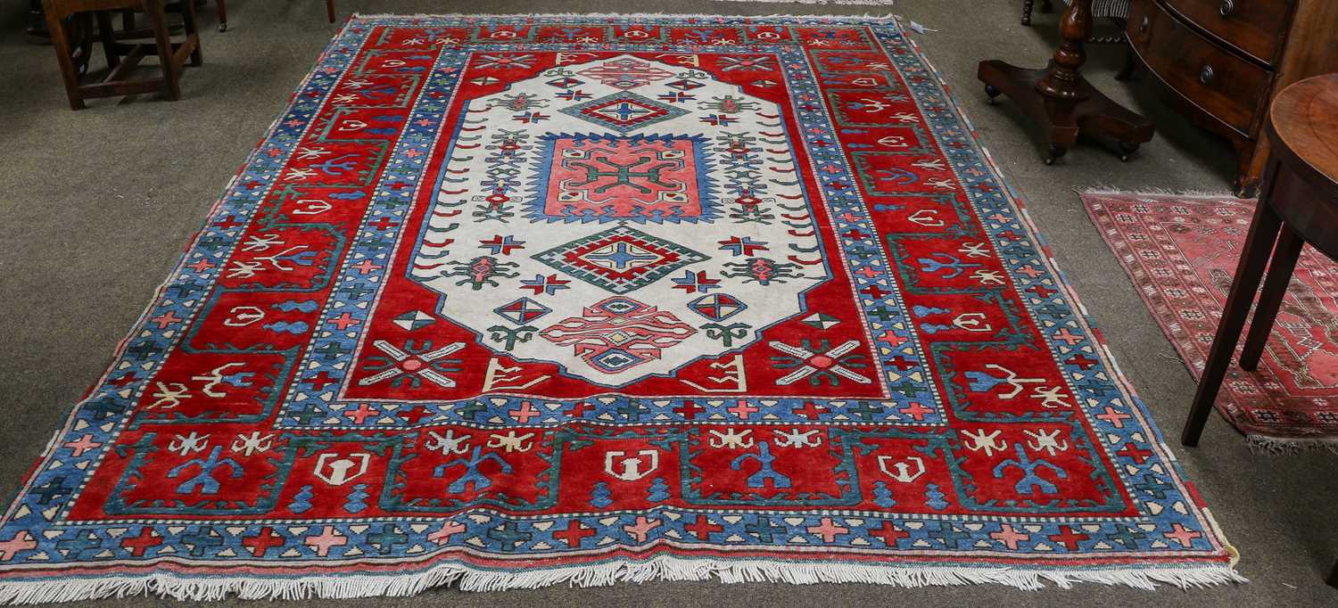 Turkish Carpet, the ivory lozenge field of geometric motifs framed by wide blood-red borders,