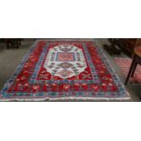 Turkish Carpet, the ivory lozenge field of geometric motifs framed by wide blood-red borders,