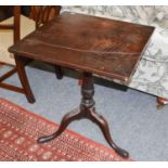 A George III Mahogany Three-Tier Dumb Waiter, with turned supports rasied on three legs