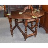 An Oak Gateleg Dining Table, 18th century, with turned baluster supports and moulded bar stretchers,