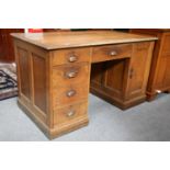 A Oak Kneehole Desk, early 20th century, 137cm by 75cm by 80cm