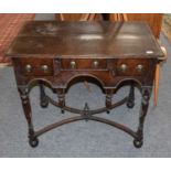 An Oak Lowboy, 18th century, the turned legs joined by shaped stretchers, 78cm by 46cm by 71cmSplits