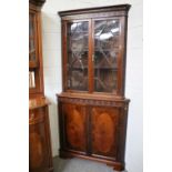 A Reproduction Mahogany Part-Glazed Standing Corner Cupboard, with dentil cornice and blind fret
