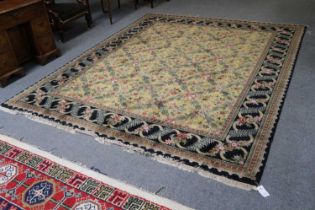 An Oriental Carpet, the pale lemon diamond lattice field of floral design enclosed by meandering