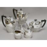 A George V Silver Teapot, Birmingham, 1928, oval, the lower body part fluted, engraved with an