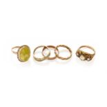 Five Rings Comprising, a 9 carat gold textured band ring, finger size O1/2, a 9 carat gold band