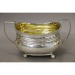 A George III Silver Sugar-Bowl, Maker's Mark Worn, London 1809, oblong and on four ball feet, with