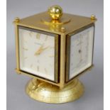 A Gilt Metal Revolving Desk Compendium Retailed by Bucherer Swiss, circa 1970, comprising timepiece,