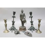 A Pair of Patinated Bronze Candlesticks, late 19th century, the sconces decorated in relief with