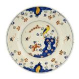 An English Delft Plate, circa 1760, painted in colours with an exotic bird amongst foliage and