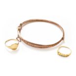 A 9 Carat Gold Bangle, inner measurements 5.9cm by 4.7cm; A 9 Carat Gold Signet Ring, finger size N;