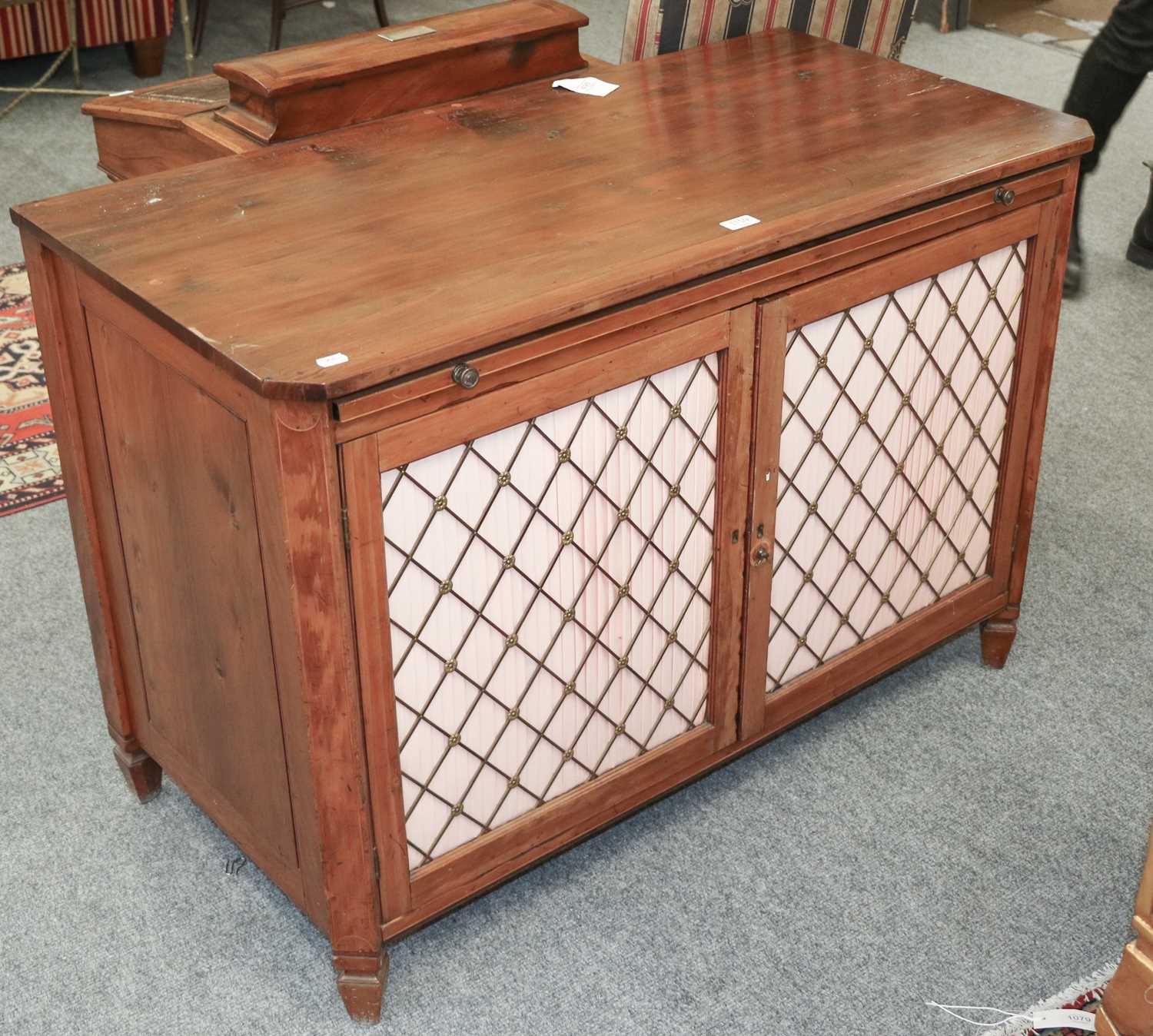 A Regency Style Inlaid Side Cabinet, with brushing slide, canted corners and brass grill fronted