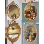 A Gilt framed Girandole Oval Wall Mirror, with mercury plate, tied ribbon pediment and twin