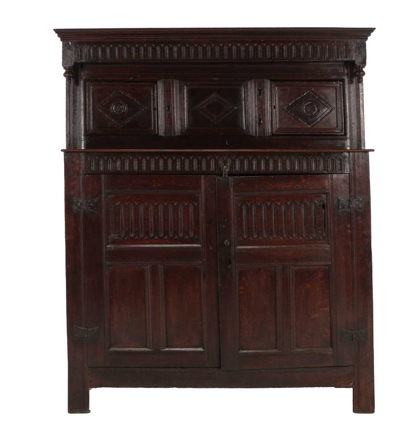 A 17th Century Joined Oak Press Cupboard, the nulled frieze above two moulded cupboard doors with