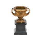 A Brass Cast Warwick Vase Car Mascot, in the form of a twin-handled urn of campana form, the base