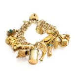 A 9 Carat Gold Fancy Link Bracelet, hung with sixteen various charms including a pig, a cross, a