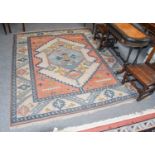 Turkish Carpet, with ivory ground. a central stylised medallion, flanked by salmon pink spandrels