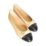 Chanel, a Pair of Beige and Black Lambskin Ballerina Flats with crossed C's to the toes, bow detail,