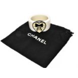 Chanel, a White Resin Hinged Bracelet with a heart shaped applique in black and cream with central