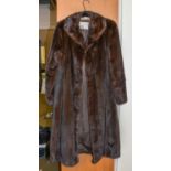 A Dark Brown Mink Coat, three-quarter length, labelled Eaton