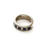 A Sapphire and Diamond Half Hoop Ring, stamped 'K18', finger size NNB: One sapphire deficient. Gross