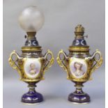 A Pair of Sevres Style Twin-Handled Pedestal Vases, converted to oil lamps, ground in cobalt blue