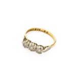 A Diamond Three Stone Ring, stamped ‘18CT’, finger size N1/2The ring is in fair condition, with