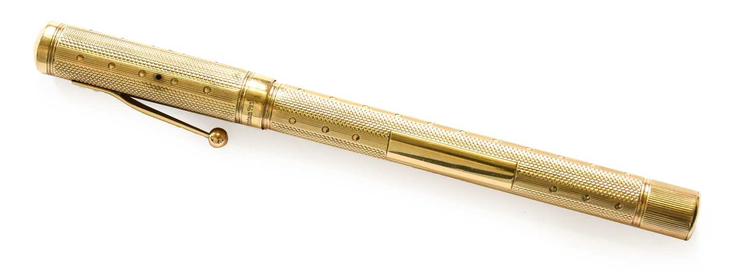 A Gold Waterman's Ideal Fountain Pen, London, 1929, 9 Carat with screw cap and overall engine-turned