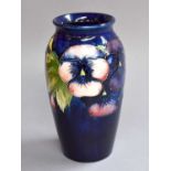 A William Moorcroft Vase, decorated with the Pansies pattern on a cobalt blue ground, impressed mark