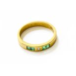 An Emerald and Diamond Half Hoop Ring, finger size M1/2The ring is in fair condition with abrasion