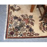 A Tabriz Carpet, the ivory field with semi-naturalistic floral sprays centred by a medallion and