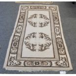 A Nepalese Rug, the ivory field with three roundel medallions enclosed by bat-wing borders, 170cm by