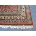 An Indian Carpet, the terracotta field with an all-over lattice design of serrated leaves and