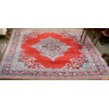 A Mahal Carpet, the blood red field centred by a floral medallion, framed by spandrels and