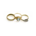 A Blue Zircon Ring, stamped '14K', finger size N; A Diamond Three Stone Twist Ring, stamped '9CT