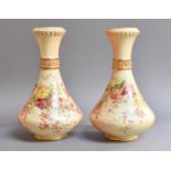 A Pair of Royal Worcester Blush Ivory Vases, painted with floral sprays, 28cm (a/f)