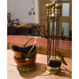 A Brass Fireside Companion Set, A Helmet Form Coal Scuttle and A Pierced Extending Fender