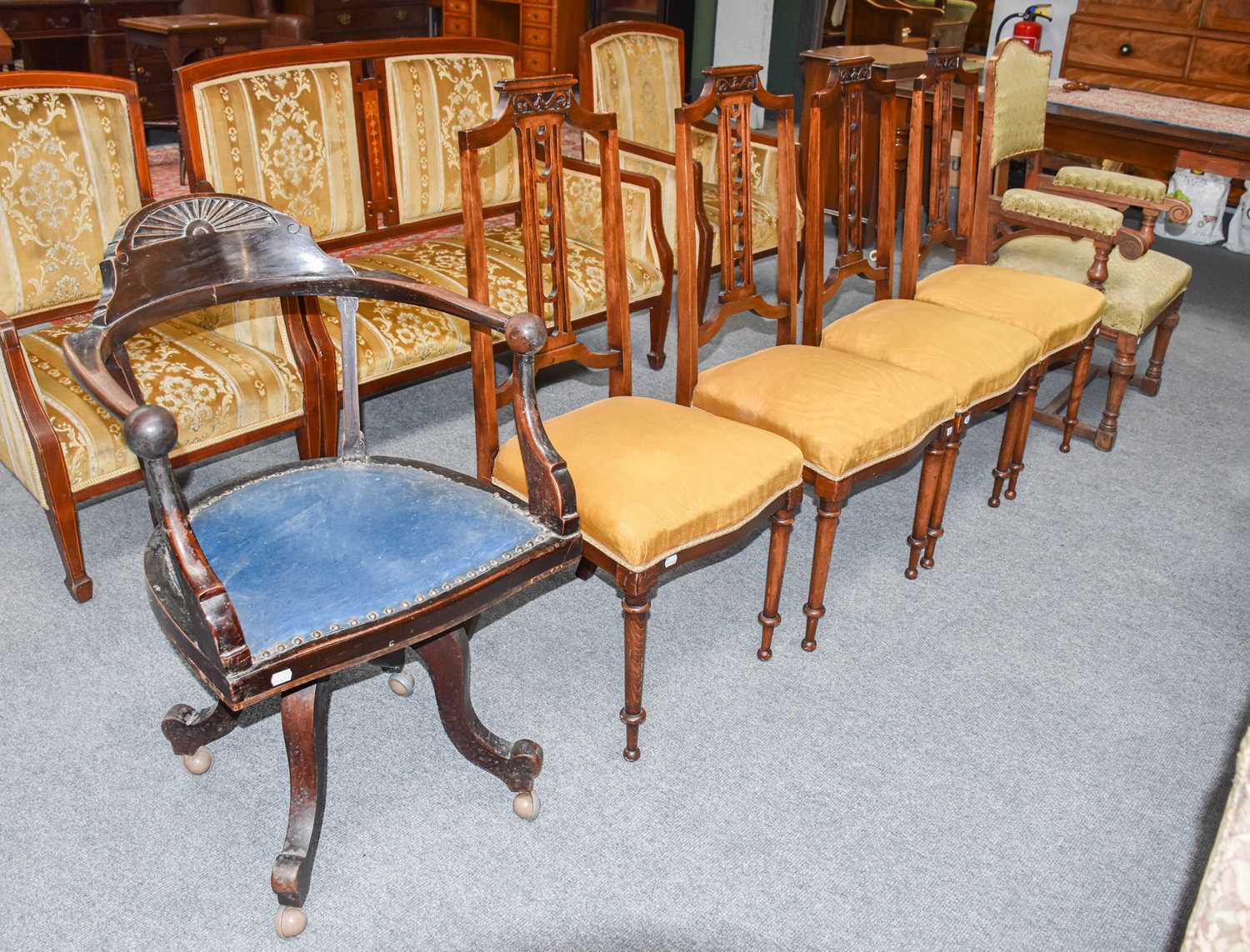 A Carved Mahogany Office Chair, circa 1910, with studded leather seat and later castors, A Set of